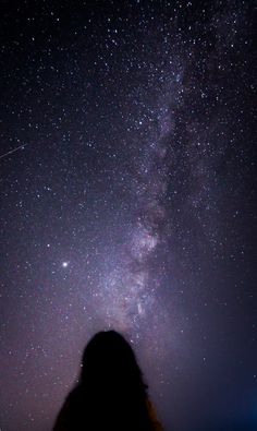 a person looking up at the stars in the sky