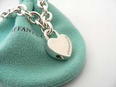 Overview:Offered for sale is a wonderful and gorgeous Tiffany & Co. Sterling Silver "LOVE" Heart Padlock Bracelet. Hanging from its bright Tiffany silver chain is a classic and very pretty "LOVE" Heart Padlock charm! A classic Tiffany piece that any girl will adore! The Padlock charm opens and closes, and thus allows you to wear the charm on a necklace or as part of another charm bracelet! Super cool and versatile piece! It is simple, elegant, and classic all rolled into one piece. Imagine t Padlock Bracelet, Heart Padlocks, Gift Love, Bracelet Bangle, Simple Elegant, Tiffany Heart, Heart Bracelet, Heart Charm Bracelet, Tiffany & Co.