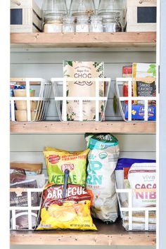 the shelves are filled with various food items and containers, including bags of chips or cereals