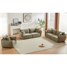 a living room filled with furniture on top of a hard wood floor covered in white rugs