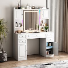 a white desk with a mirror and lights on it next to a potted plant