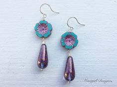 These beautiful earrings were created with 14mm turquoise and purple Czech glass hibiscus beads and 20x9mm bronzed purple Czech glass teardrop beads. These stunning earrings dangle from silver plated ear wires and measure 2 1/4 inches in length. These romantic and gorgeous earrings would be the perfect gift for you or someone special. ~All of my listings are handmade with love and ready to ship...All orders will arrive to you in a gift box with bow for easy gift giving~ Turquoise Teardrop Czech Glass Earrings, Turquoise Teardrop Flower Earrings For Gift, Hibiscus Earrings, Czech Beads Jewelry, Czech Glass Jewelry, Earrings Boho Chic, Dangle Earrings Boho, Jewelry Tips, Turquoise Earrings Dangle