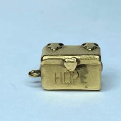 One Mid-Century 14k Yellow Gold Charm, It Is A Chest Box, It Read "Hope" In Front, (The Letter E Worn Out). The Chest May Be Able To Open, It Has Hinges Flat Handle In Front, But I Unable To Open It. It Measures 14 X 7.5 X 8.3mm, Weight 2.2gm, Hallmark 14k Hope Box, Letter E, Gold Charm, Hinges, Hallmark, Mid Century, Yellow Gold, Women Jewelry, Yellow