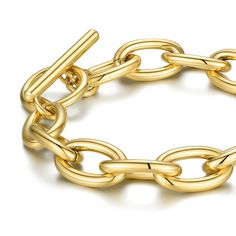 Introducing the Link Bracelet, a stylish and versatile piece of jewelry that is perfect for any occasion. This beautiful bracelet features large links and is crafted from high-quality materials and finished with 14K gold plating, giving it a luxurious and sophisticated look. At 7.9" in length, the Link Bracelet is the perfect size for most wrists. Its large links make it a statement piece that is sure to catch the eye of anyone who sees it. The toggle lock ensures that the bracelet stays securel Formal Gold Bracelet With Chunky Oval Link Chain, Classic Gold Paperclip Bracelet With Chunky Chain, Classic Gold-tone Bracelet With Chunky Chain, Gold Formal Chain Link Bracelet, Modern Gold-tone Chunky Chain Bracelet, Formal Gold Link Paperclip Bracelet, Formal Gold Chain Link Bracelet, Modern Chain Link Charm Bracelet For Formal Occasions, Gold-tone Gold Bracelet With Chunky Oval Link Chain