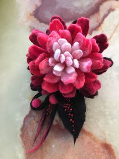 Hand felted , one of a kind, decorative, with change of angle changes its look, made using merino wool, bamboo silk,beads, soap and water. Soft and silky.Pin it to your sweater, scarf, bag or hat. Have fun. Thanks.i use usps two days priority shipping for USA customers . Handmade Pink Flower Brooches, Red Handmade Flower Brooches, Handmade Red Flower Brooches, Red Flower-shaped Brooch With Handmade Flowers, Scarf Bag, Nuno Felt, Fabric Embellishment, Felt Projects, Bridal Gloves