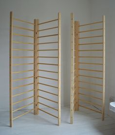 an empty room with three wooden dividers in it