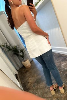 Unleash your inner boss babe in our White Strapless Blazer Top! This unique top features a blazer look with buttons down the front and a split front hem, giving you a professional yet chic look. Show off those shoulders and slay in style. Model is wearing a size small. Stocked at Arlington Village. Chic Fitted Strapless Blouse, Chic Strapless Top For Formal Occasions, Chic Strapless Formal Tops, Elegant Tube Top For Spring Going Out, Chic Tube Top For Date Night, Chic Fitted Tube Top For Day Out, Fitted Chic Tube Top For Day Out, Chic Formal Tube Top, Chic Spring Tube Top For Going Out