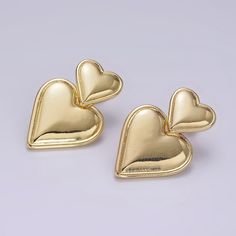 If you receive a defective item, please contact us within 5 days of arrival. Item Details - - Sold as a pair - Materials: Brass, 14K gold filled - Nickel free and lightweight, perfect for everyday wear - Push back stud fastening Please avoid any water or chemical solutions. Keep the item in a dry environment. Yellow Gold Metal Earrings For Valentine's Day, Valentine's Day Yellow Gold Metal Earrings, Valentine's Day Yellow Gold Earrings, Gold Double Heart Earrings For Anniversary, Gold Earrings For Anniversary On Valentine's Day, Gold-tone Heart-shaped Pierced Earrings, Gold-tone Heart Earrings, Gold Double Heart Nickel Free Earrings, Gold Pierced Earrings For Valentine's Day