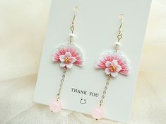 pink and white crochet flower dangle earrings with thank you written on it