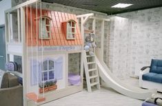 there is a doll house with a slide in the room