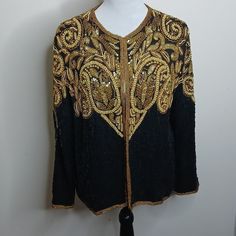 In Very Good Condition Only Two Small Spots Where The Beads Fell Off . As Seen In Pictures. But The Jacket Comes With Replacement Beads. New With Tags Beaded Sequined Black And Gold Kinda Heavy In Weight Super Fancy Floral Vintage Made Of Silk With Rayon Lining Elagent Coat / Jacket Along Sleeve Size Medium Pit To Pit Measurment Is 20 Inches Height From Top Of Shoulder To Bottom Is 24 Inches Across Torso Is 20 Inches Sleeve Length Is 22 Inches Spring Embellished Gold Outerwear, Embellished Gold Outerwear For Spring, Gold Embellished Outerwear For Spring, Festive Fitted Beaded Outerwear, Black Embellished Cardigan For Party, Beaded Fall Festive Outerwear, Fitted Long Sleeve Beaded Outerwear, Festive Beaded Fall Outerwear, Elegant Beaded Festive Outerwear