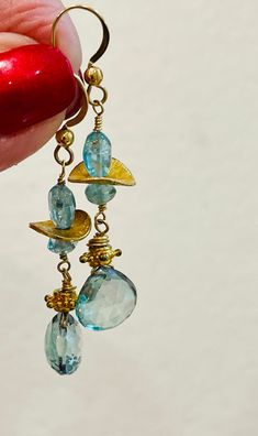 Topaz Earrings Gold dangle drop Earrings Blue gemstone earrings November birthstone by Gem Bliss.  Please note the actual sizes /details given as items may look different depending on your display.  * Images are enlarged to show detail.  ~ 14K Gold-filled Hook earrings.  ~ Topaz briolettes 11 mm.  ~ Apatite oval beads 8 mm.  ~ Apatite  rondelles 5 mm.  ~ 1-1/2-inch drop.  Amazing Aqua Blue Topaz Quartz and Apatite combination drop Earrings.  Sparkling faceted heart shape Topaz briolettes earrings.  Looking blue, then aqua and green this gem combination creates the glam for this Spring fresh earring.  One-of-a-kind luxury for the November birthday!  Lovely Mother's Day, Graduation, or Valentine's Day gift.  Apatite Topaz Earrings come with a jewelry pouch in a gift box tied with a lush ribb Blue Topaz Faceted Dangle Earrings, Faceted Blue Topaz Dangle Earrings, Nickel-free Blue Topaz Dangle Earrings, Blue Topaz Dangle Earrings, Blue Topaz Dangle Earrings For Gift, Handmade Blue Topaz Dangle Earrings, Turquoise Blue Topaz Dangle Earrings, Topaz Dangle Earrings For Gift, Blue Apatite Earrings Gift