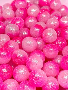 pink and white candies in a bowl with glitter on the top, as if they were candy