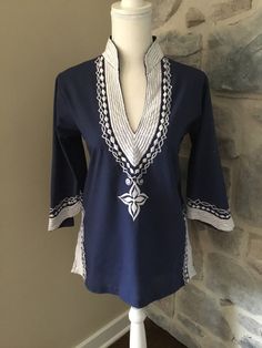 This embroidered tunic shirt is a great, fun shirt with bell, 3/4 length sleeves. The embroidery is amazing and it is in great condition! Size - Small Shoulder to Bottom - 26" Shoulder to Shoulder - 15.5" Spring Embroidered Kurta With 3/4 Sleeves, Spring Kurta With Floral Embroidery And 3/4 Sleeves, Long Sleeve Tunic With Embroidered Hem, Bohemian Long Sleeve Tops With Machine Embroidery, Traditional Long Sleeve Tunic With Embroidered Hem, Traditional Long Sleeve Tunic With Embroidered Sleeves, Fitted Cotton Kurta With 3/4 Sleeves, Long Sleeve Tops With Geometric Embroidery For Vacation, Traditional Summer Tops With 3/4 Sleeves