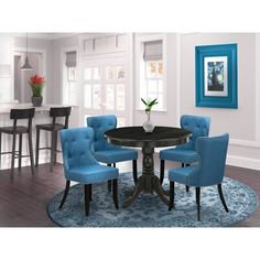 a round dining table with blue chairs around it