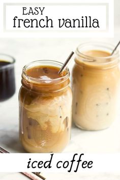 two jars filled with iced coffee sitting next to each other