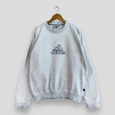 "REMINDER: THIS IS USED CLOTHING PLEASE DO NOT EXPECTED IT LIKE TO BE NEW OR IN PRISTINE CONDITION Feel free to contact me for any question. I'll assist you with my pleasure. Vintage 1990s ADIDAS Crewneck Distressed Sweatshirt Medium Adidas Equipment Sportswear Sweatshirt Adidas Sport Pullover Gray Sweater Size M *All measurements are taken with the garment flat on the ground. SIZE ON TAG :- Size M ACTUAL SIZE MEASUREMENT :- ARM PIT TO ARM PIT :- 23\" inches BACK COLLAR TO HEM :- 26\" inches CONDITION :- GREAT USED CONDITION. HAVE DEFECTS (KINDLY REFER TO THE PICTURES ATTACHED) ** WE ARE USING DHL EXPRESS, IT TAKES 3-5 WORKING DAYS ONLY TO ARRIVE. PLEASE LEAVE YOUR PHONE NUMBER ON THE NOTE WHILE MAKE A PURCHASE** REF : (14-01-2021) 904" Athleisure Sweatshirt With Three Stripes Branding, Crew Neck, Adidas Three Stripes Crew Neck Sweatshirt, Athleisure Sweatshirt With Three Stripes And Crew Neck, Athleisure Sweatshirt With Three Stripes Branding, Gray Sweater For Streetwear In Sportswear Style, Sporty Crew Neck Sweatshirt With Three Stripes Branding, Casual Sweatshirt With Three Stripes For Sports Season, Three Stripes Crew Sweatshirt For Streetwear, Sporty Adidas Logo Crew Neck Sweatshirt