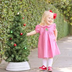 This Twinkly Tree Red Single Smocked Dress is perfect for Christmas gatherings. This red gingham dress features a single smocked Christmas tree adorned with a bow on top. The adorable bishop sleeves and collar are accented with red tape trim, adding a festive touch. Red Gingham Dress, Toddler Christmas Outfit, Monogram Outfit, Christmas Gathering, Hand Smock, Smocked Dress, Toddler Christmas, Red Gingham, Gingham Dress