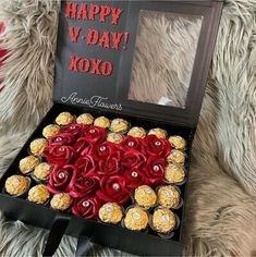 a valentine's day box filled with chocolates and roses in the shape of a heart