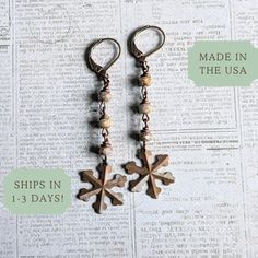 These Christmas Snowflake Earrings capture the essence of a vintage Victorian winter with their long, dangly design. Perfect as a stocking stuffer, they make a charming Christmas gift for your daughter or sister. 𝗗𝗘𝗧𝗔𝗜𝗟𝗦 ❄️ Drop length of earrings is 2 inches from base of ear wires ❄️ Ear wires are made in the USA of lead/nickel-free antiqued brass ❄️ Beautiful Czech glass in gray/gold stone finish ❄️ Antiqued brass snowflake charms are made in the USA ❄️ Antiqued brass throughout for a v Bohemian Christmas Jewelry, Handmade Vintage Jewelry For Holidays, Vintage Handmade Holiday Jewelry, Victorian Winter, Winter Earrings, Charming Christmas, Snowflake Earrings, Earring Gift, Gift For Sister