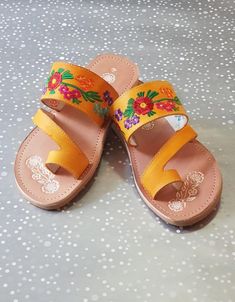 Mexican Sandals are made with soft insole and durable outsole. Rubber sole for comfortable walking! Strips are made with leather and decor with mexican embroidered. Huaraches are perfect as Summer shoes. They are unique and original.Easy to wear with jeans, dresses and shorts.*Need special size? - Please send a message, gladly assit you! We have more designs*In wholesale special prices!(Remember that because are made of leather it is required to use them to fit them)Shipping:Ready to ship within Orange Single Toe Strap Sandals For Spring, Yellow Bohemian Sandals With Round Toe, Yellow Bohemian Round Toe Sandals, Yellow Bohemian Leather Sandals, Bohemian Yellow Leather Sandals, Bohemian Yellow Sandals For Spring, Yellow Leather Bohemian Sandals, Floral Embroidered Round Toe Sandals For Beach, Traditional Closed Toe Sandals With Floral Embroidery