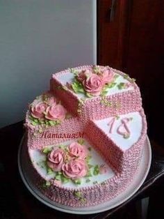 a three layer cake with pink roses on top and the number twenty two in the middle