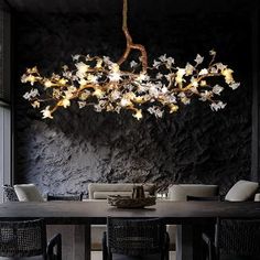 a dining room table with chairs and a chandelier hanging from it's ceiling