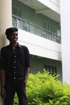 a man standing next to a tall building