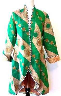 Specialty Collection: Mid Length Designer Jacket Is New and Fully Reversible. Kantha Stitching In emerald or the reverse side, honey.  This beautiful NEW handmade vintage cotton kantha jacket is produced by artisans from the nomadic desert tribe known as "Banjara ", Northern India. This jacket is fully reversible; offering two varied prints. Great value. Design detailing is visible throughout the garment. Black and white piping finishes all seams, highlighting the colors and prints well. The col Traditional Green Long Sleeve Outerwear, Traditional Green Outerwear For Fall, Nomadic Desert, Shadow Wizard, Value Design, Kantha Jacket, Kimono Design, Designer Jacket, Vintage Saris