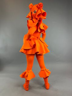 About this item Step into the spotlight with our vibrant Neon Orange Clown Exotic Dancewear – an elegant fusion of futuristic fashion, Coachella vibes, and trending club couture. This unisex bodysuit doubles as a Halloween showstopper and zentai fashion statement.Costume Details:Lycra Headpiece: A head-sock with big eye holes and fabric pointsils adorned with hand-made roses. Comfortable and easy to see through.Fabric: Lycra 4-way stretch and soft, glowing under fluorescent lights.Long Zipper on Creature Costume, Clown Outfit, Head Sock, Futuristic Clothing, Coachella Vibes, Catsuit Costume, Fluorescent Lights, Exotic Dance, Coachella Outfit