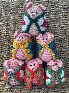 several small crocheted pigs are stacked on top of each other