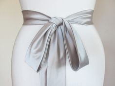 Fitted Evening Sash With Tie Back, Fitted Tie Back Sash For Evening, Silver Fitted Sash For Party, Fitted Silver Sash For Party, Elegant Satin Sash With Tie Back, Satin Ribbon Bridal Belt For Parties, Elegant Bridal Belt With Satin Bow For Wedding, Evening Sash With Satin Bow, Elegant Bridal Belt With Satin Bow For Bridesmaid