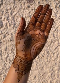 a woman's hand with hennap on it, showing the intricate design