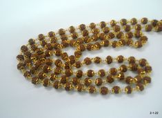 "20kt gold and rudraksha beads chain necklace mala (108+1=109 Beads) from rajasthan india. great handmade chain, good for jewellery collection. Note - Please check pictures carefully for more details. Length - 102 cm(40.2\") we can adjust the length. Thickness - 6/6.5 mm gross weight approx - 29.5 grams gold weight approx - 20 grams Material - 20kt yellow gold & rudraksha beads." Handmade Gold Temple Jewelry Mala, Brown Necklaces For Puja And Festivals, Festival Brown Necklace For Puja, Gold Beads With Beaded Chain For Festivals, Gold Temple Necklace With Gemstone Beads For Festivals, Traditional Brown Beaded Chain Jewelry, Traditional Brown Beaded Chain, Gold Mala With 8mm Beads For Meditation, Gold Mala With Round Beads For Festivals