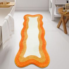 an orange and white bathroom rug on the floor