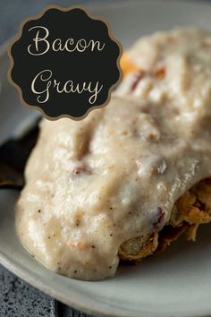 a close up of a plate of food with gravy on it and a fork