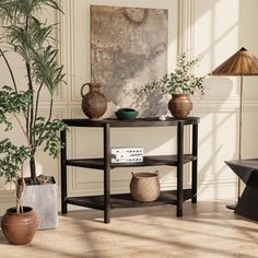 a living room with potted plants and a table in the corner, next to a couch