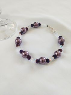 Mauve colored glass bead bracelet with purple glass beads and clear sparkling crystals. This beautiful accessory adds pop! to any outfit with its stunning, rich color and illuminating sparkle. The bracelet in photo is 8 to 8.5  inches long with extension (can be made to order according to wrist size/circumference). Please feel free to message me! Purple Beaded Bracelets For Wedding, Purple Round Bead Crystal Bracelet For Parties, Purple Round Beads Crystal Bracelet For Party, Purple Crystal Round Beads Bracelet For Party, Purple Round Beaded Crystal Bracelet For Parties, Purple Crystal Beaded Bracelets As Gift, Elegant Purple Crystal Bracelet With Spacer Beads, Purple Crystal Bracelets With Round Beads, Purple Beaded Crystal Bracelet For Party