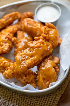 chicken wings with sauce in a bowl on a table