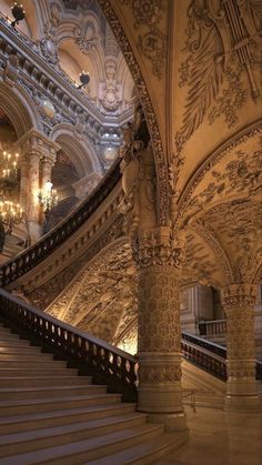 an ornate staircase with chandeliers in a building