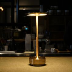 a table lamp sitting on top of a wooden counter next to a kitchen stovetop