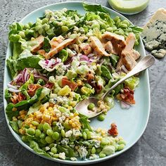 a blue plate topped with salad and dressing