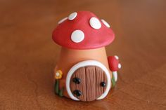 a small toy mushroom sitting on top of a wooden table