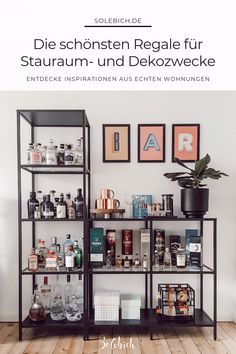 a shelf filled with lots of bottles and liquors next to a plant on top of a hard wood floor