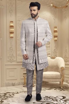 This men's sherwani, style U2-S351, features an open jacket design and intricate thread work. Offering a traditional and elegant look, this sherwani adds a touch of sophistication to any occasion. Expertly crafted, it exudes quality and fine craftsmanship. Elevate your style with this stunning piece. Formal Winter Sherwani Straight Kurta, Elegant Front Open Kurta For Eid, Traditional Style Front Open Formal Sets, Traditional Front Open Sets For Formal Occasions, Traditional Front Open Formal Set, Elegant Front Open Kurta For Wedding, Elegant Long Sleeve Sherwani For Diwali, Formal Outerwear With Zari Work For Transitional Season, Winter Ceremonial Sherwani With Traditional Drape