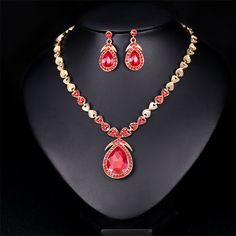 Make sure your elegant look sparkles with this set that includes a statement-making necklace and matching drop earrings. Includes red crystal and cubic zirconia drop earrings and necklace (three pieces total) Earrings: 0.67" W x 1.38" L Chain : 16.14" L with 2.76" extender Pendant : 1.02" W x 1.85" L Lobster claw clasp 18k gold-plated copper / crystal / cubic zirconia Earrings And Necklace, How To Make Necklaces, Red Crystals, Bridal Jewelry Sets, Elegant Jewelry, Lobster Claw, Jewelry Set, Bridal Jewelry, Cubic Zirconia