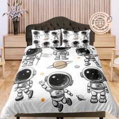 a bed with an astronaut print on it