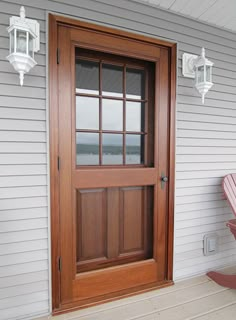 a wooden bench sitting on the front porch next to a door with glass panes