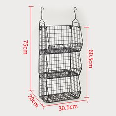 three tiered wire basket hanging on the wall with measurements for each item in front of it