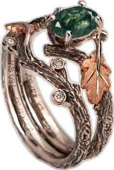 two rings with leaves and an emerald stone on top, set in gold plated silver